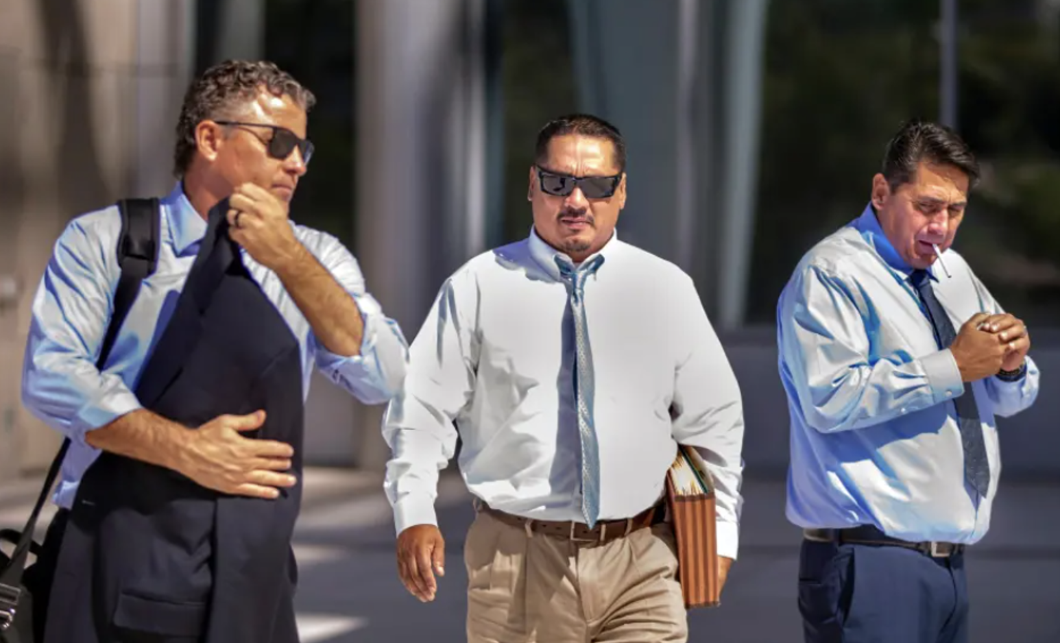 *Mark Fleming, walks with Albert Lopez outside the Lloyd George U.S. Courthouse Thursday, Feb. 6, 2020, following opening statements.