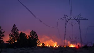 California wildfire burns under power lines